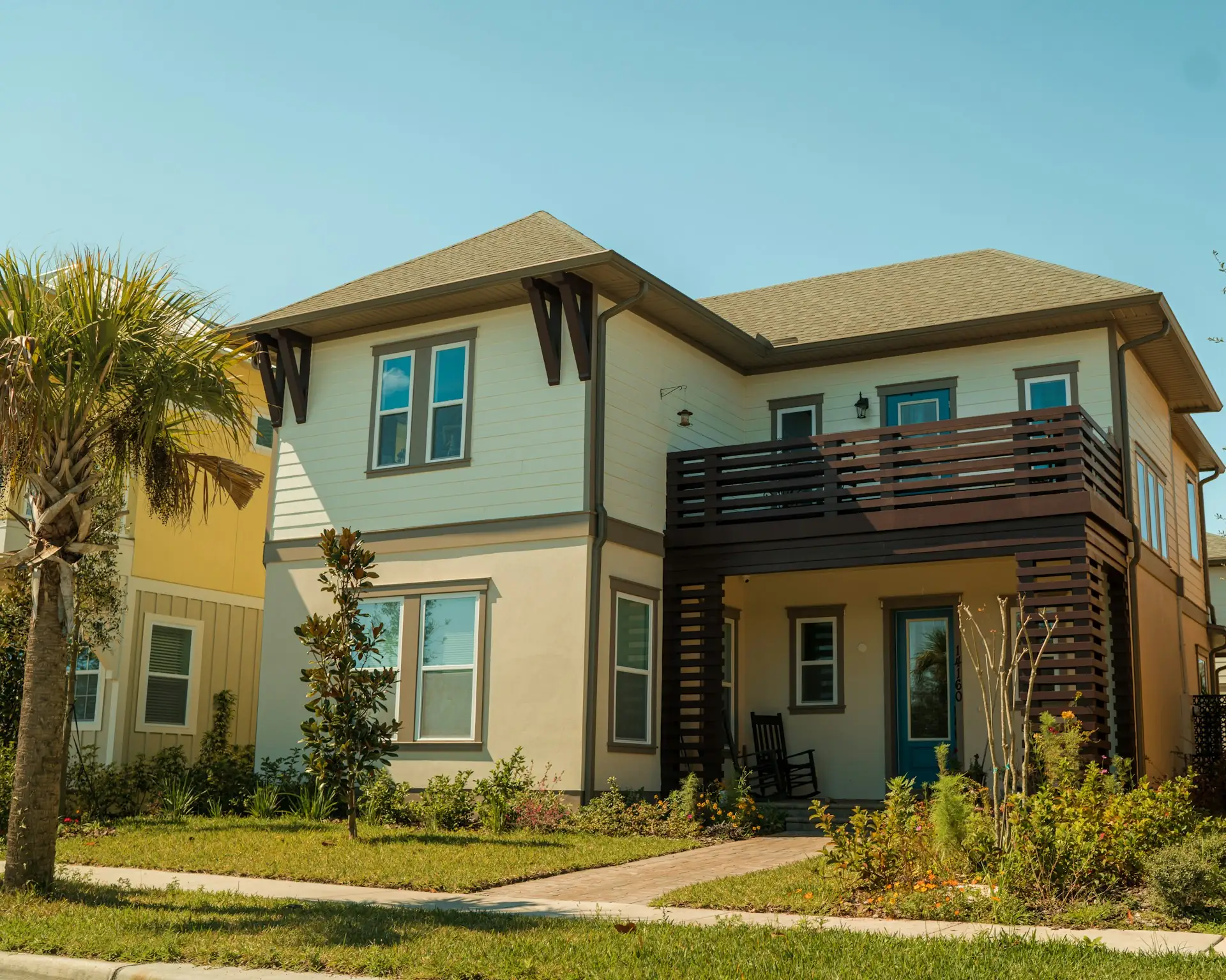 Two-story Florida home with a palm and a fresh, even finish
