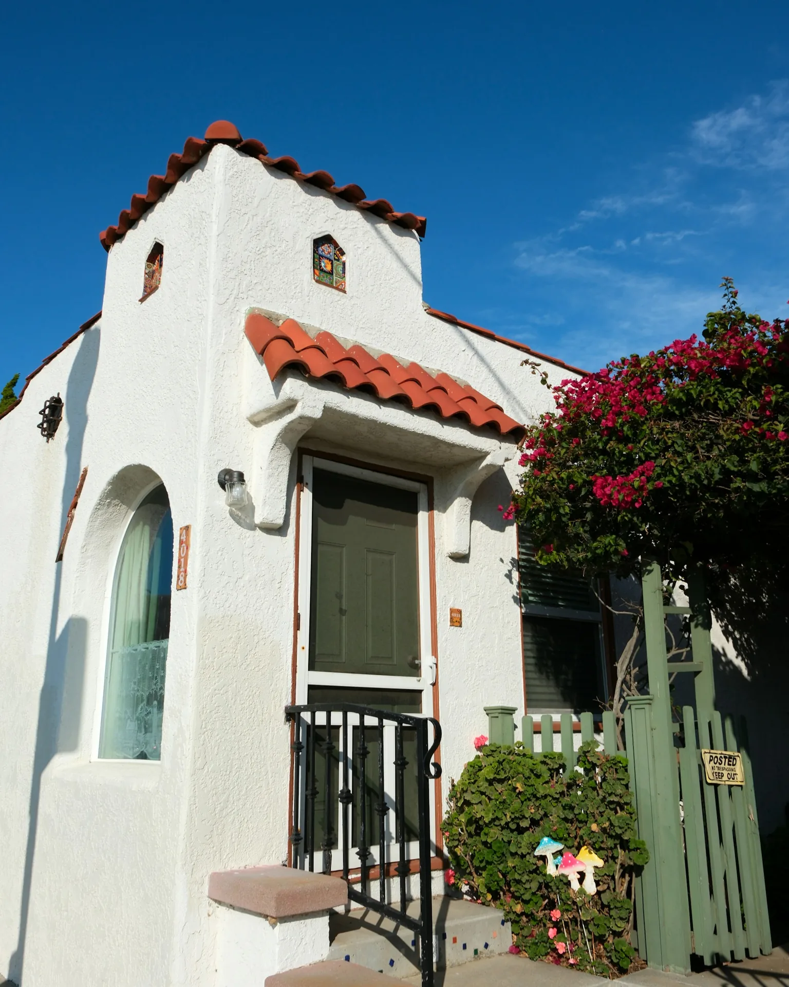 White stucco home with red tile roof